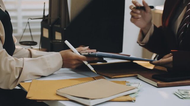 justice and law concept.Male judge in a courtroom on wooden table and Counselor or Male lawyer working in office. Legal law, advice and justice concept.