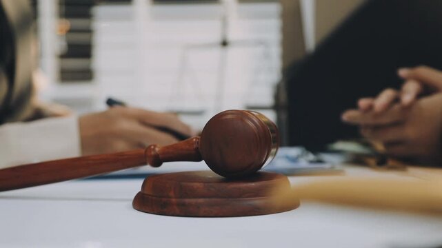 justice and law concept.Male judge in a courtroom on wooden table and Counselor or Male lawyer working in office. Legal law, advice and justice concept.