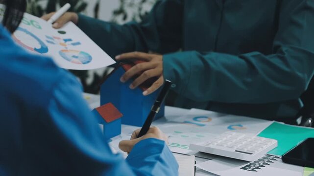 Business leaders discuss implement environmental sustainability strategies net zero carbon goals corporate responsibility using ESG reports data at meeting