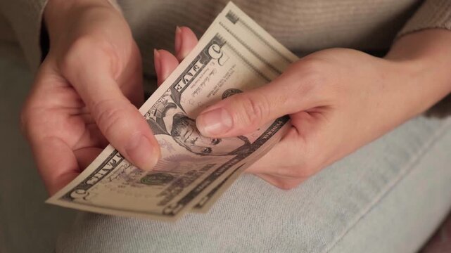 Closeup Hands Counting Cash Woman, Fingers Flipping Dollar Bills, Folding, Gripping Notes, Domestic Budget. Bankruptcy, Poverty, Inability to Pay. Lack of Funds, Money Problems, Financial Illiteracy