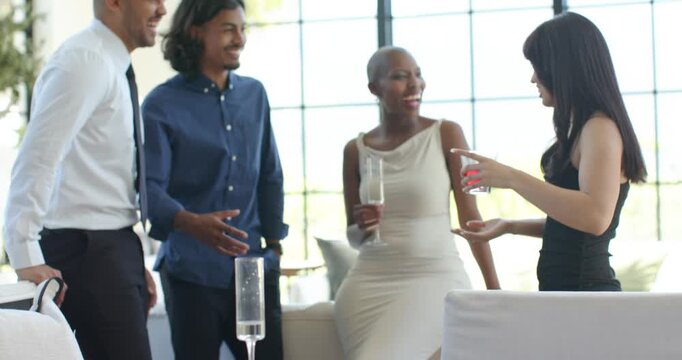 African American friends in formal wear toasting in living room, camera panning table showing pizza