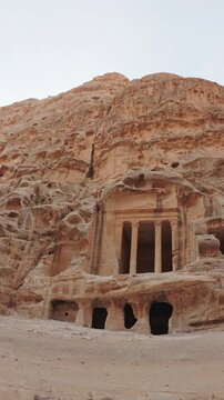 Timelapse vertical view Little Petra Siq al Barid Nabataean Triclinium rock cut dining hall carved in sandstone cliffs archaeological site near Petra Jordan