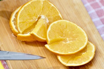 Cutting orange outdoors.on the green grass in the garden. High quality FullHD footage