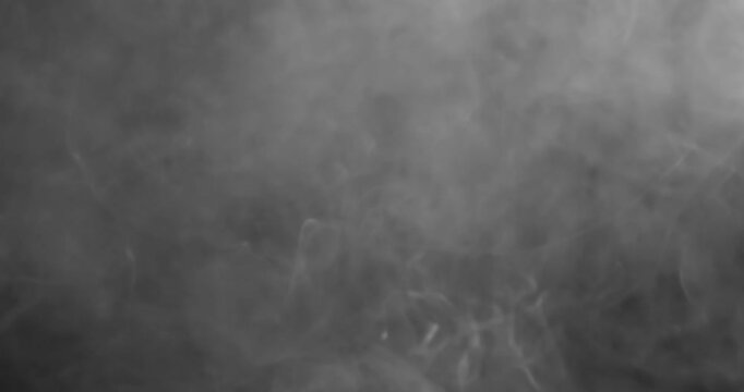 black and white smoke explosion slowly floating through space against black background