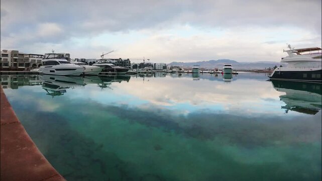 Aqaba, Jordan - 6th december, 2025: timelapse vertical view Ayla Marina Aqaba Jordan waterfront promenade with marina yachts Red Sea coastal development timelapse urban travel scene