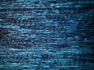 Abstract dark blue ink background with horizontal wavy lines and organic natural texture