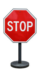 Red stop sign with white letters on a dark grey metal pole, standing on a round base