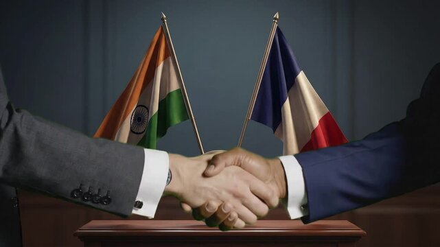 Formal handshake between diplomats symbolizing a strong political and economic partnership between India and France