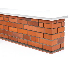 Brick wall fragment with smooth white coping; corner view