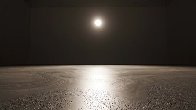 Single light in empty space. A single light source turns on in an empty dark space, gradually illuminating the surrounding area with a soft glow.