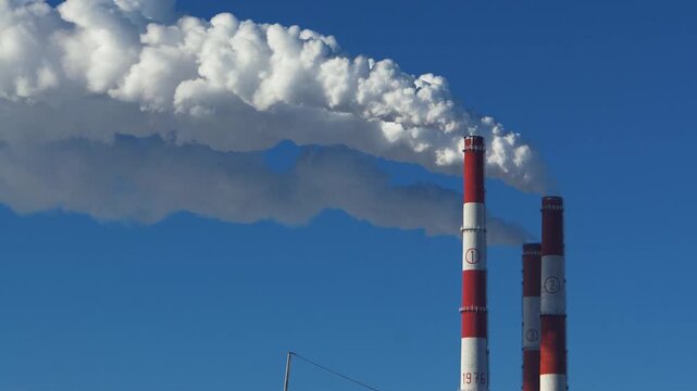 Chimneys of a thermal power plant.  Timelapse, accelerated shooting. problems with thermal energy and electricity.