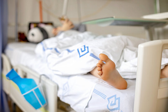 Preteen child, boy, lying in hospital with fractured thoracic spine, vertebralis