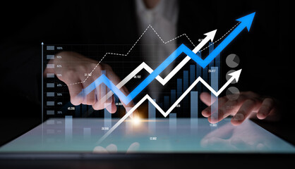 Professional setting featuring a business person analyzing financial data on a tablet. Upward trend...