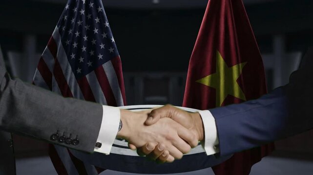 Two diplomats firmly shake hands symbolizing a crucial diplomatic agreement between the United States and Vietnam nations.