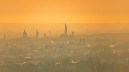 Fototapeta premium Sunset with Straubing city towers silhouettes seen from Mount Bogenberg, Bogen, Danube, Bavaria, Germany