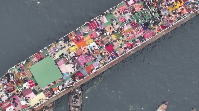 Dhaka, Bangladesh - 10 February 2026: Aerial view of a ship full of people surrounded by smaller boats, creating a vibrant contrast against the water.