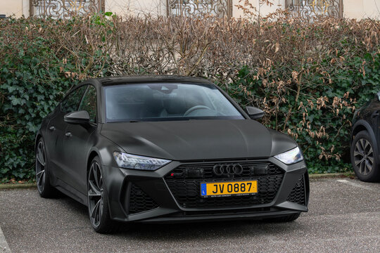 Nancy, France - January 31st 2026 : View on a matte black Audi RS7 parked on a street with a hedge and a building in the background.