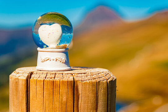 Crystal ball, with a heart inside, alpine autumn or indian summer landscape shot Mount Grosser Rettenstein in the background at Mount Resterkogel, Mittersill, Oberpinzgau, Salzburg, Austria
