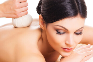 Young woman relaxing in a spa on a back massage