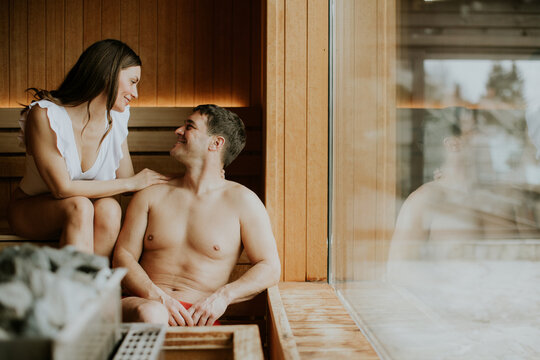 Couple enjoys warmth and connection in a serene sauna escape in the mountains