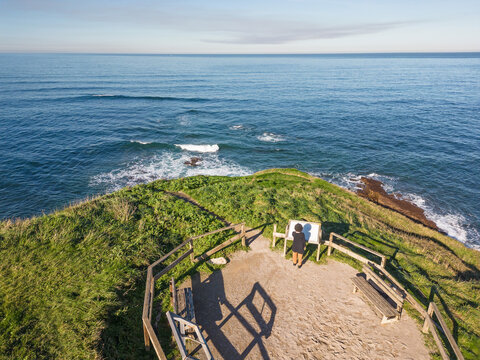 Tourist at the Punta de la Moira viewpoint in Comillas, Cantabria.
