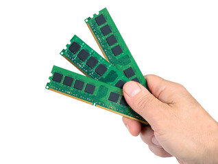 Memory sticks are shown in one hand to illustrate the current DRAM shortage in the technology market
