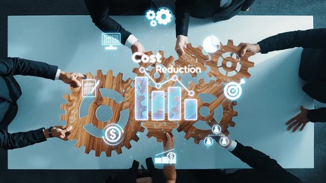 A dynamic overhead view of a business team engaged in collaborative discussions focusing on cost reduction strategies using tech-driven visual data and graphical insights. Raster