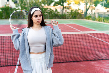 Obraz premium Woman player holding tennis racket standing on court