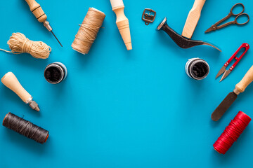 Tools for repair shoes. Hammer, awl, knife, thread on table, top view