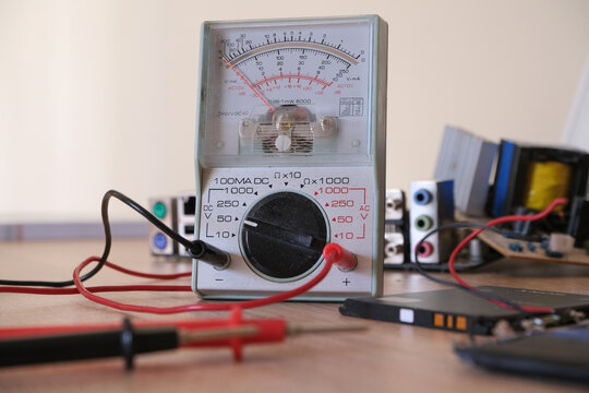 Electronics repair and restoration workbench with analog multi meter.