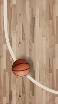 Top View Basketball on Hardwood Court with Curved Three Point Line and Copy Space
