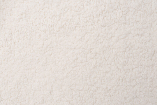 White teddy fabric texture background, top view