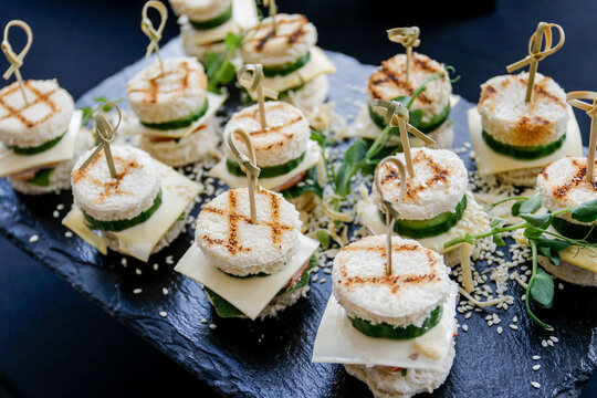 Elegant Mini Sandwiches and Canaps on a Dark Platter