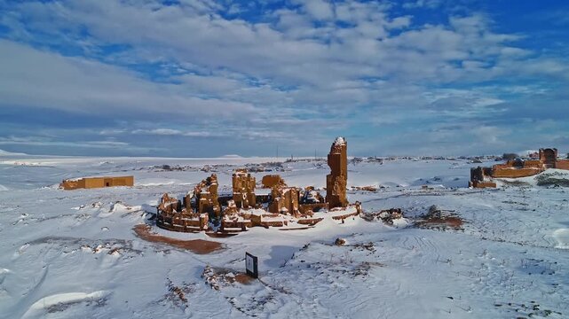 Aerial view of the Abughamrents Church ruins at Ani in Kars, Turkey. Snow covered medieval Armenian architecture stands within the vast winter landscape of the ancient city.