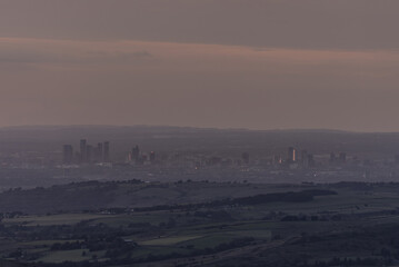 Fototapeta premium Manchester cityscape, viewed from miles away in the Peak District