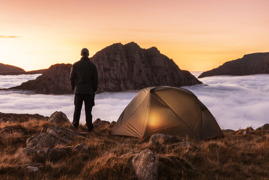 Incredible camping view witha  man on mountain in Snowdonia above the clouds