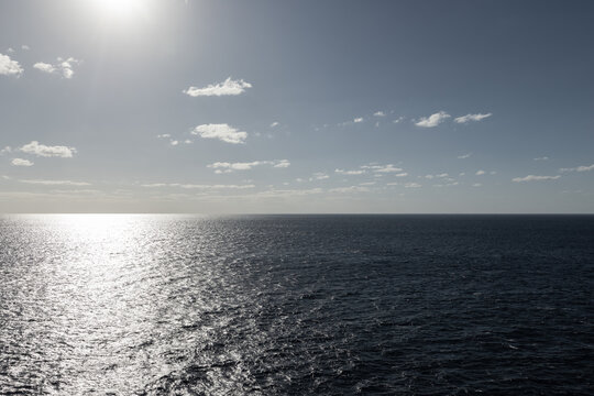 Photo of beautiful endless wide shot of ocean horizon on bight sunny day at sea sun reflection on glassy calm ocean surface.
