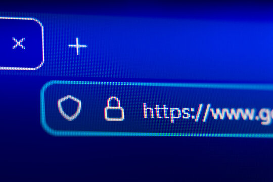Close-up of a secure web browser address bar with HTTPS protocol, padlock icon, and shield symbol, representing internet security, data privacy, and encrypted connection.