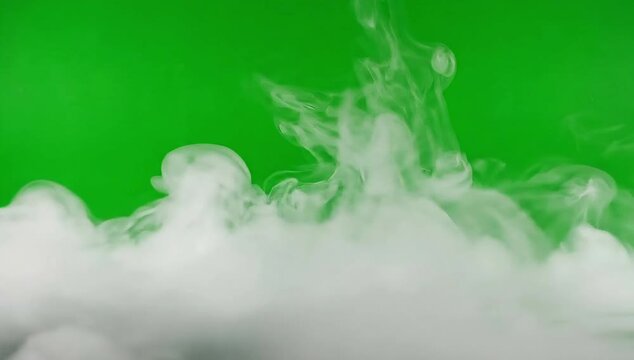 Smoke cloud spreading on green screen studio floor for compositing in video editing projects used for visual effects scenes, atmospheric transitions, and cinematic production workflows