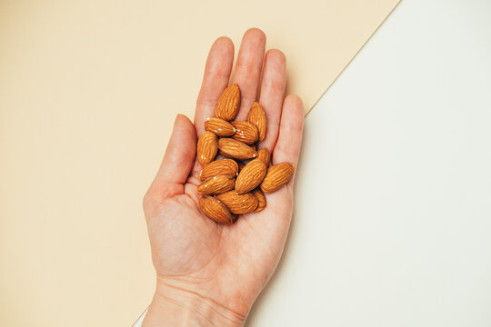 Image Features Hand Holding Almonds To Illustrate Controlled Healthy Snack With Organic Texture
