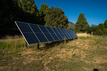 Solar panel array for sustainable renewable energy future, capturing clean power in a natural green landscape to support environmental conservation and climate action.
