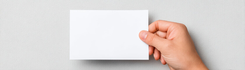 Obraz premium Blank card hand white paper holding minimal close up isolated empty message note finger human skin background object communication sign template concept blank space copy space business invitation