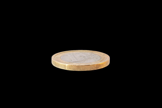 1 euro coin lying flat with the reverse side or tails view showing the face value with the European map design and edge detail, isolated on a black background.