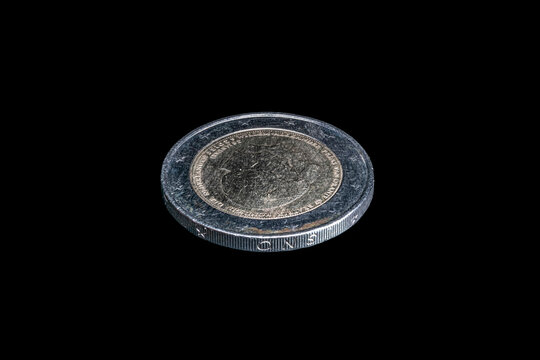 Tilted view obverse side of a 2013 Netherlands two euro coin shows a double portrait with a Dutch text reads "Beatrix Queen of the Netherlands" and her successor "Willem-Alexander, Prince of Orange." 