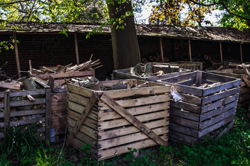 View of wooden boxes with firewood in the park.