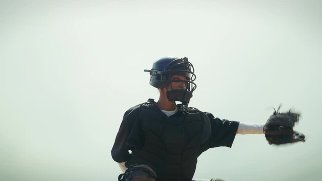 Young catcher practices her throwing skills on the field