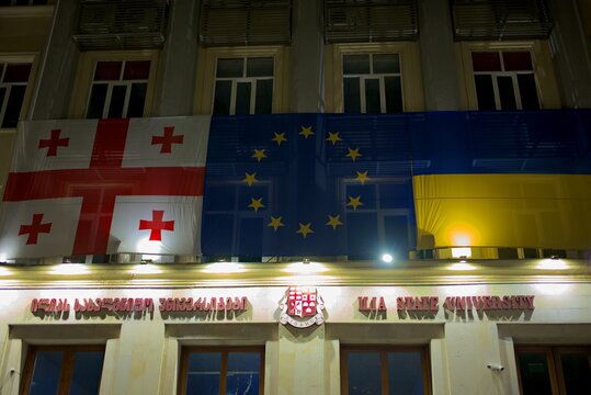 Ilia State University ISU building decorated with Georgian, EU and Ukrainian flags in Tbilisi, Georgia