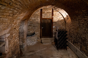 Fototapeta premium Visit of underground caves at Champagne producers, houses, fermentation and aging, riddling, process of making champagne sparkling wine in Champagne region in France