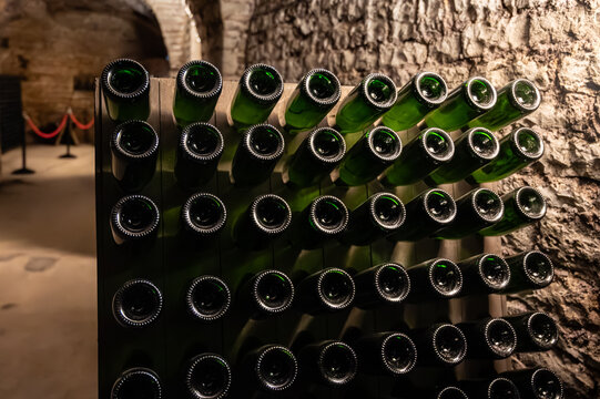 Visit of underground caves at Champagne producers, houses, fermentation and aging, riddling, process of making champagne sparkling wine in Champagne region in France