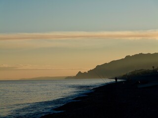 Obraz premium Sunset over the beach and coastline at Santa Teresa di Riva and Furci Siculo in January 2026, before Cyclone Harry, Sicily, Italy
